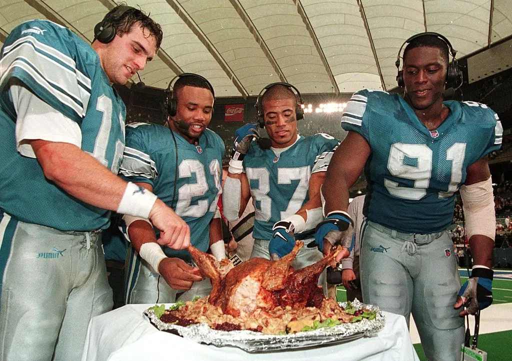 Happy Thanksgiving. NFL Players enjoying turkey dinner on the sidelines