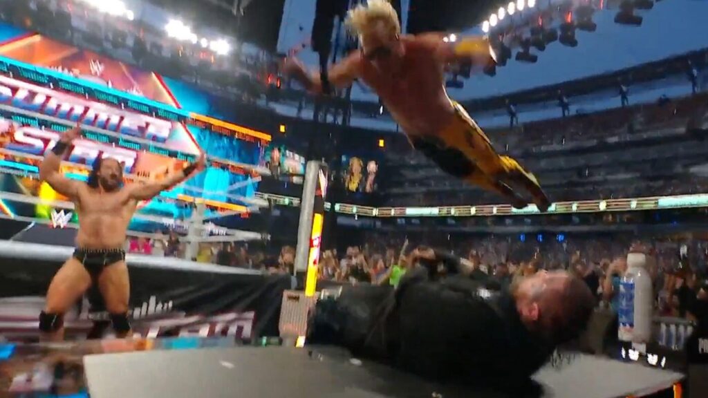 Watch as Logan Paul flies through the air and smashes Jelly Roll through an announce desk at WWE SummerSlam